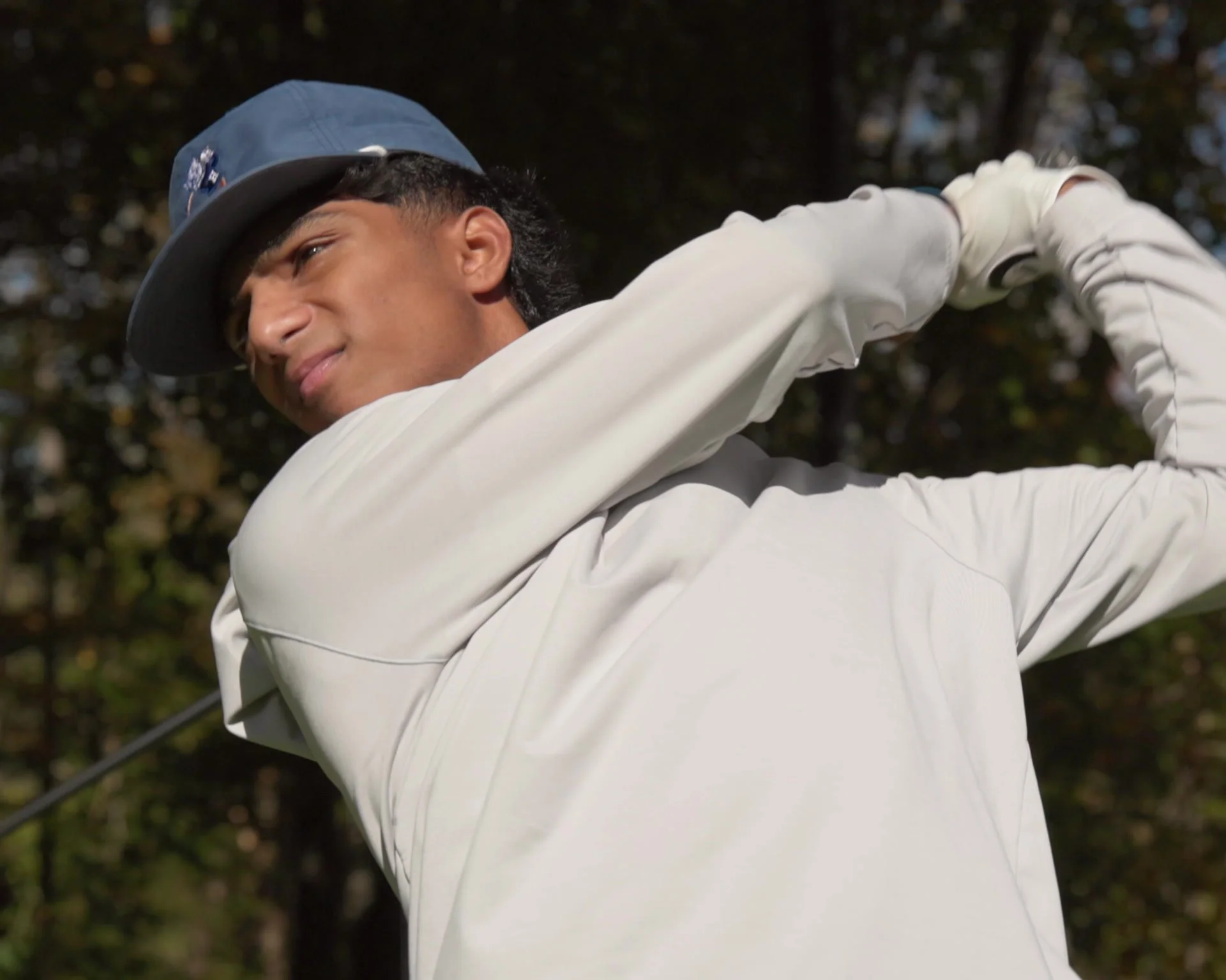 Arnav Rao finishing a golf swing on a Connecticut course