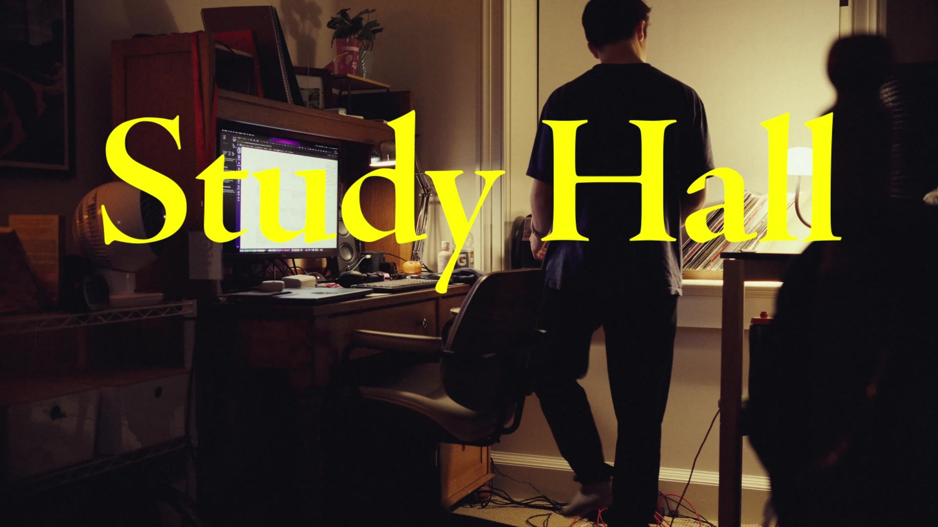 Study Hall short film title over a student working at his desk at night
