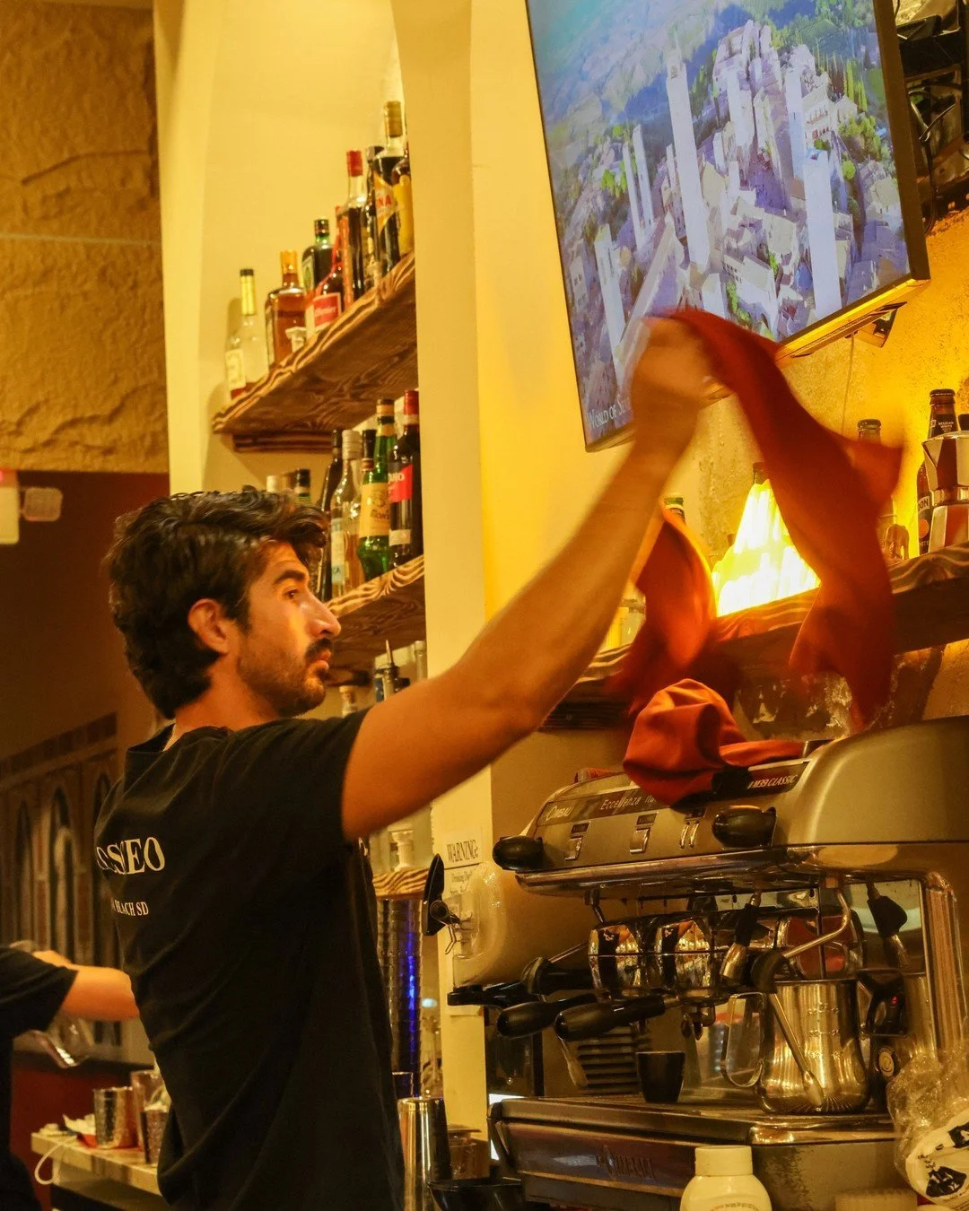Bartender at work behind a restaurant bar, hospitality content still