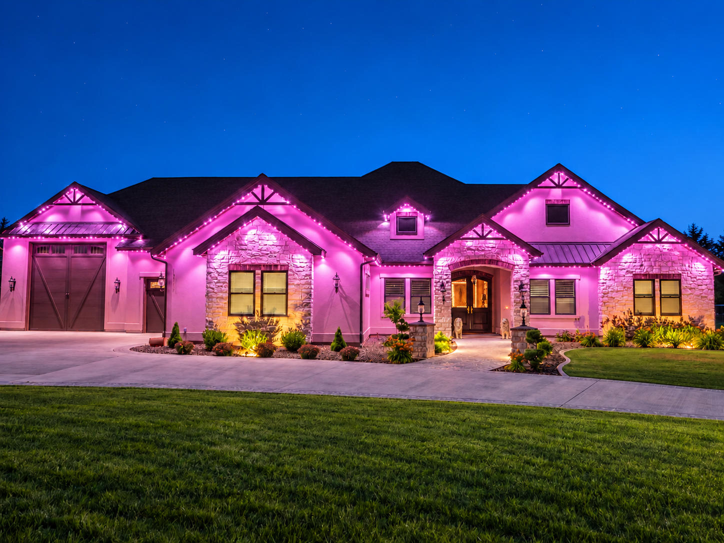 Pink permanent lighting outlines the gables and illuminates the stone exterior of a home at dusk.
