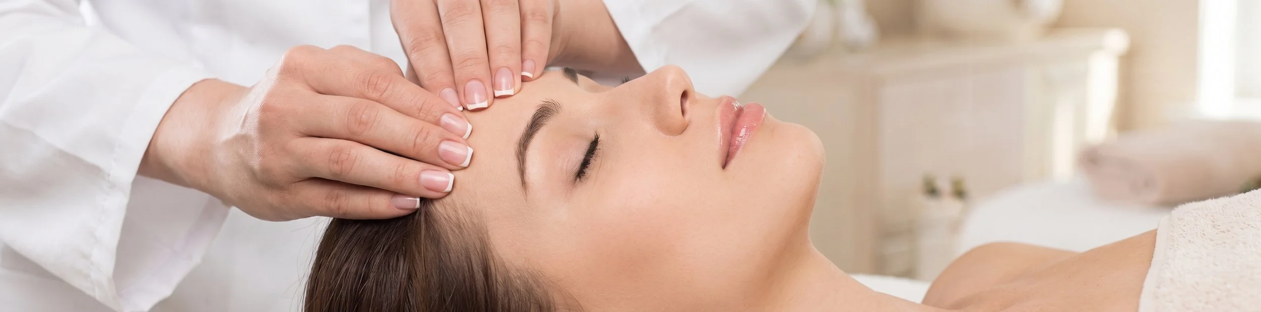 Woman receiving a relaxing facial massage at a spa