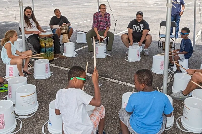 Kids playing music in a group drum circle