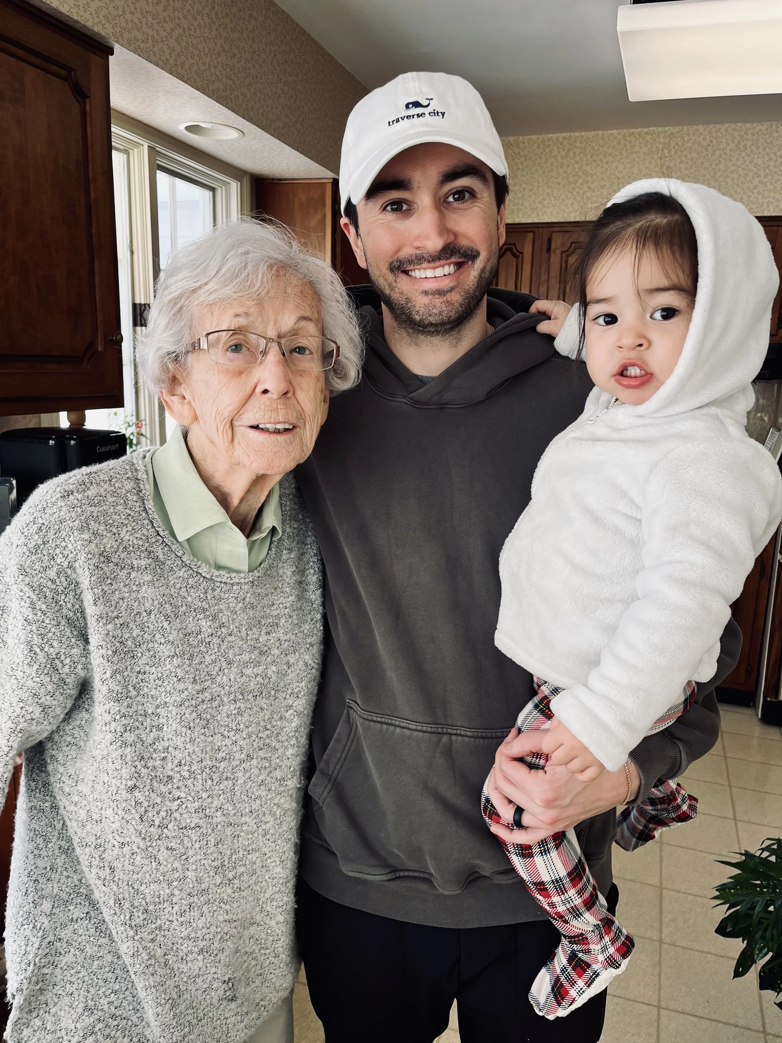 Nathan, his daughter, and his grandmother smiling for a family photo in 2025.