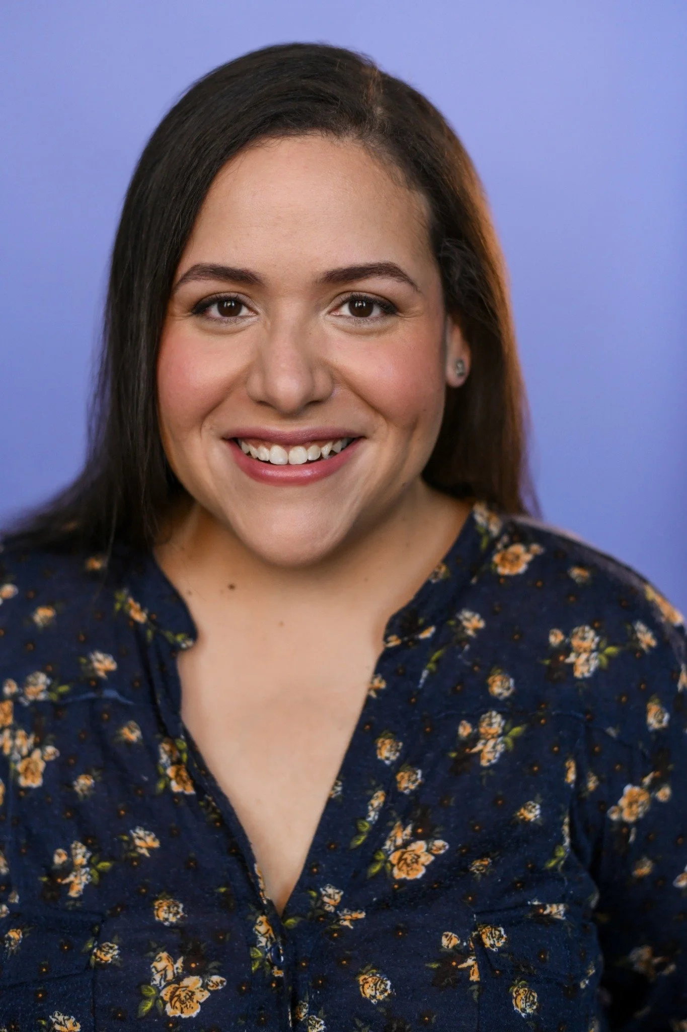 Vilmarie Rosario smiling against a lavender background.