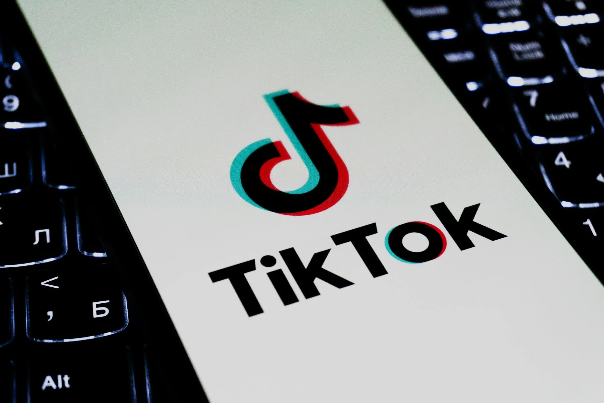 TikTok logo displayed on a laptop keyboard