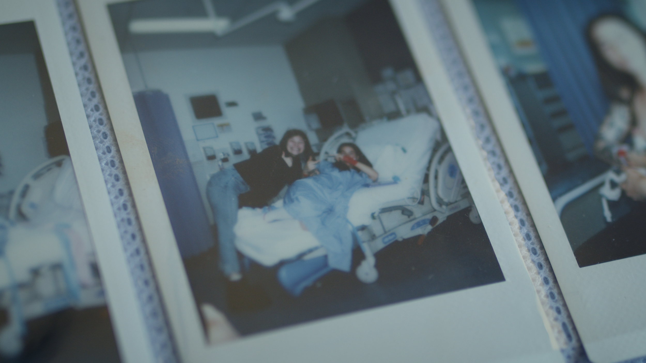A printed photo of a parent lying beside a child in a hospital bed.