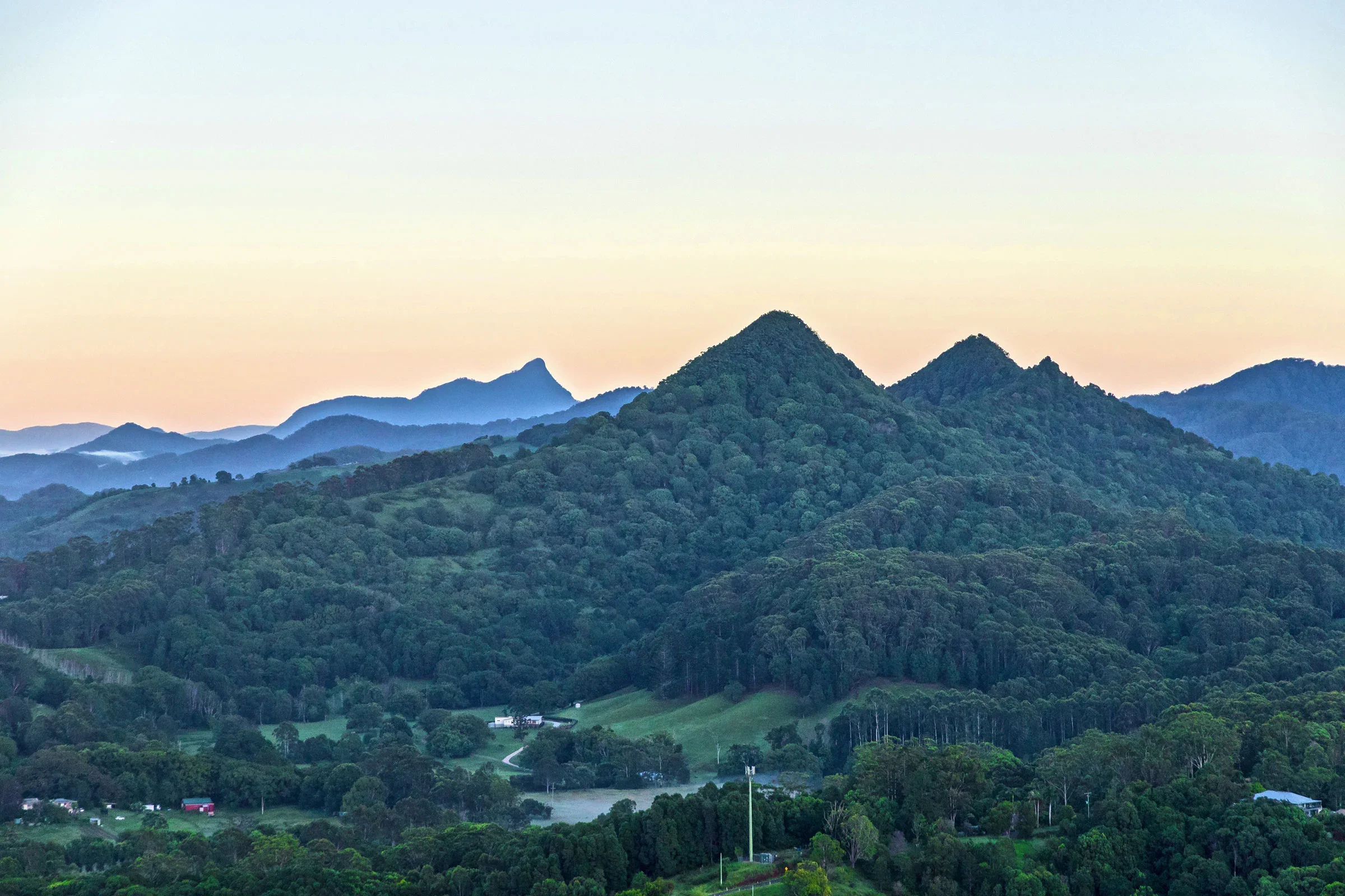Mount Chincogan, Mount Warning (Wollumbin) and the surrounding mountain ranges of the Northern Rivers hinterland at sunrise.
