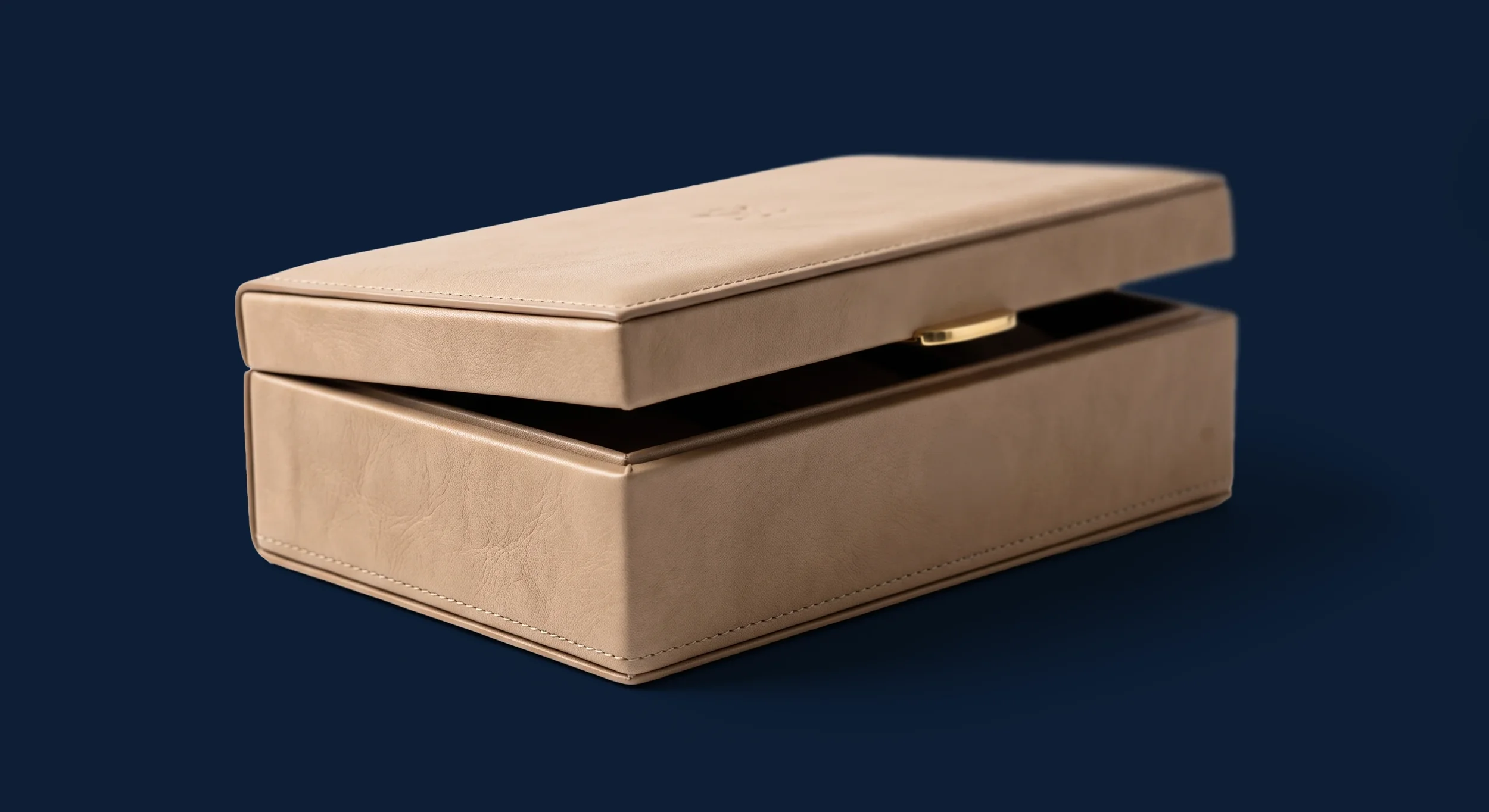 A beige jewelry box with a sliding lid, placed on a dark background.