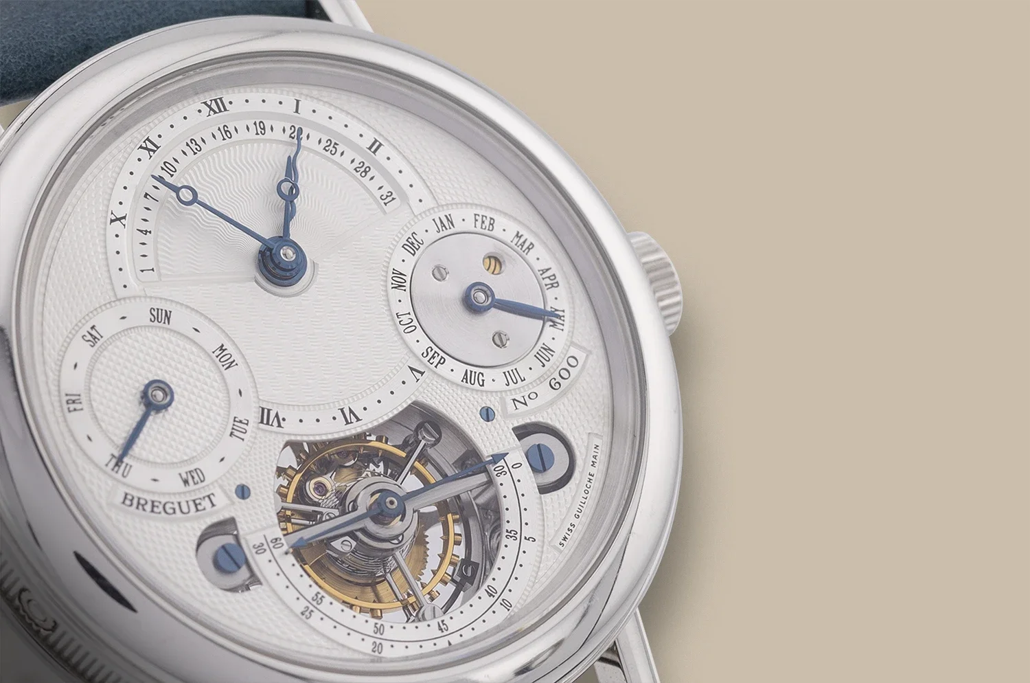 Close-up of a luxury watch with multiple dials showing time, date, day of the week, and month, with visible intricate internal mechanical parts.