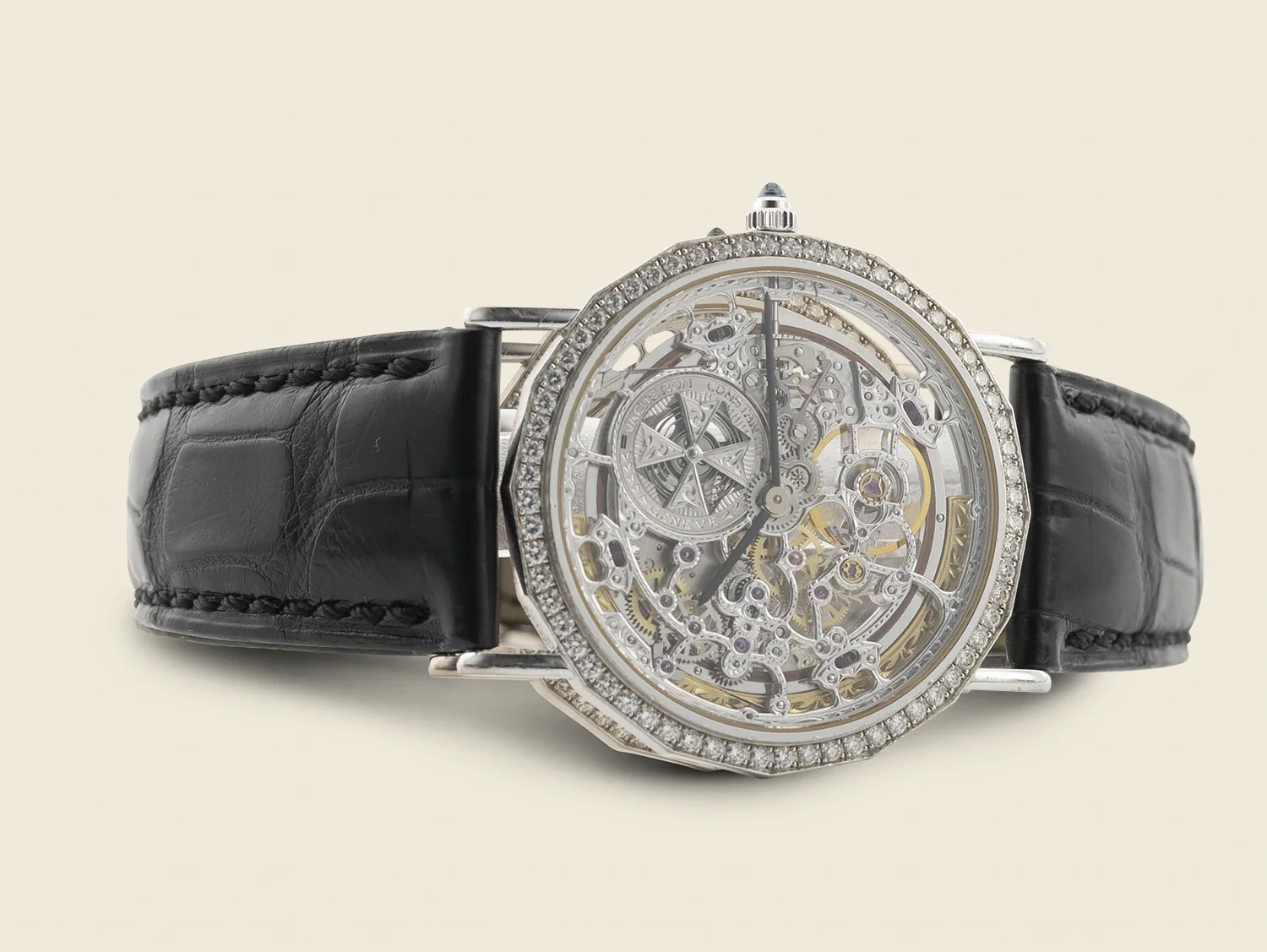 Luxury wristwatch with a skeleton dial, diamond-encrusted bezel, and black leather strap.