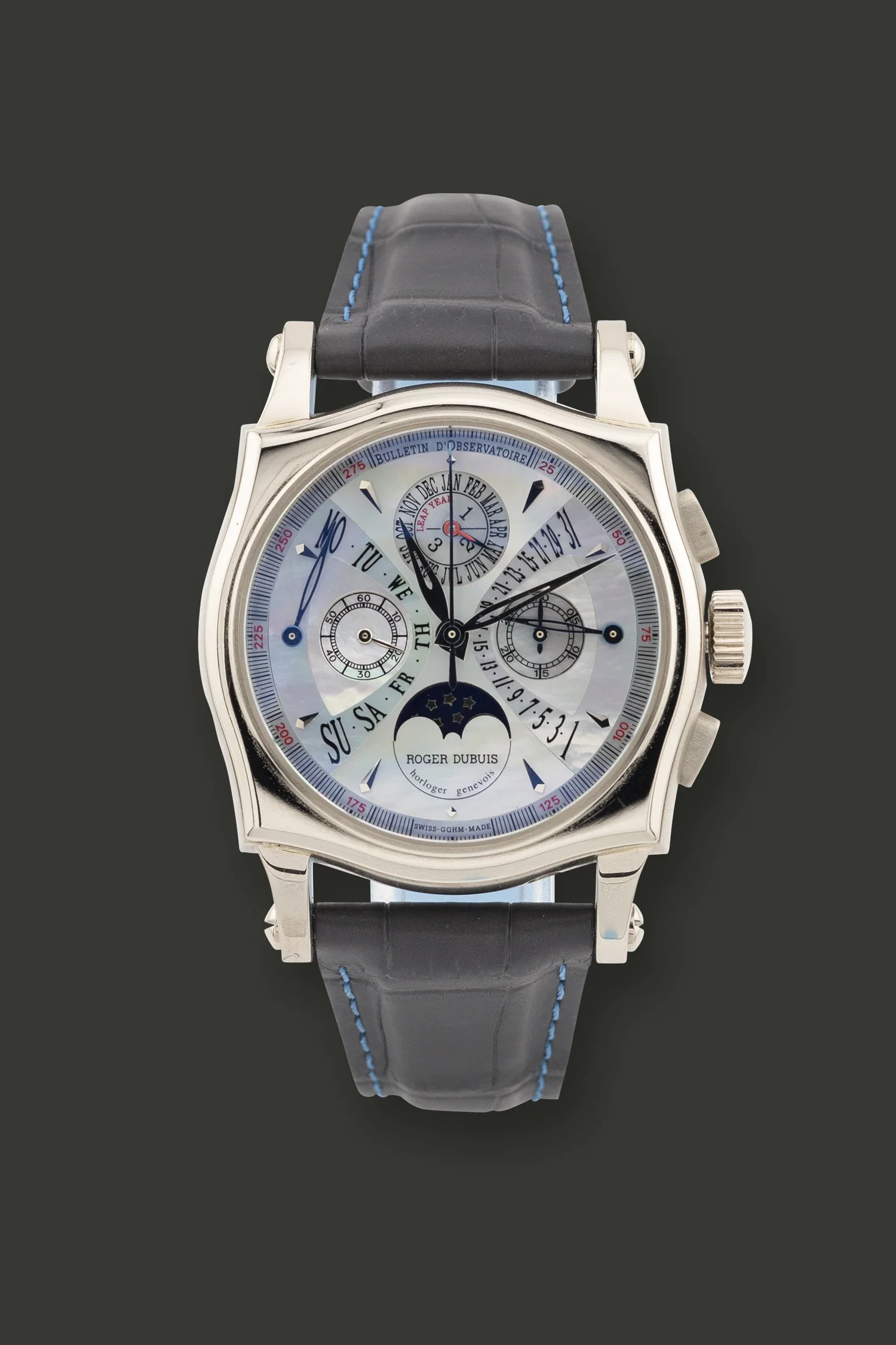 Close-up of a luxury wristwatch with a black strap, silver case, and a watch face displaying multiple dials, subdials, and numerical markings.