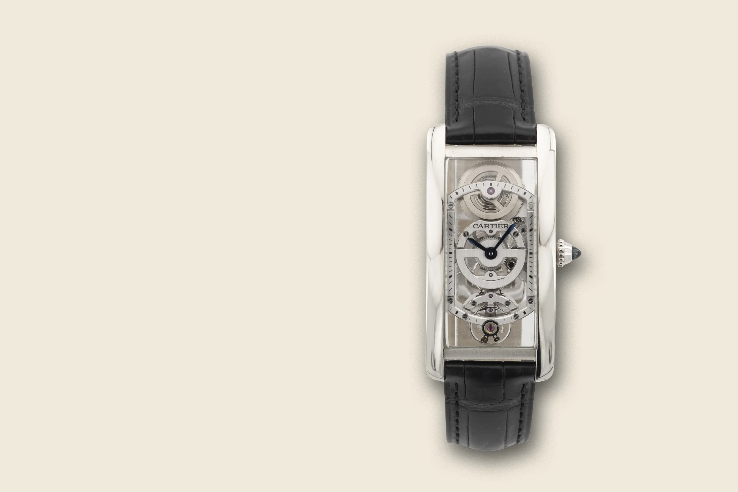 A luxury skeleton wristwatch with a rectangular silver case, black leather strap, and visible mechanical movement. The watch face displays an intricate gear system, with the time showing approximately 8:10.