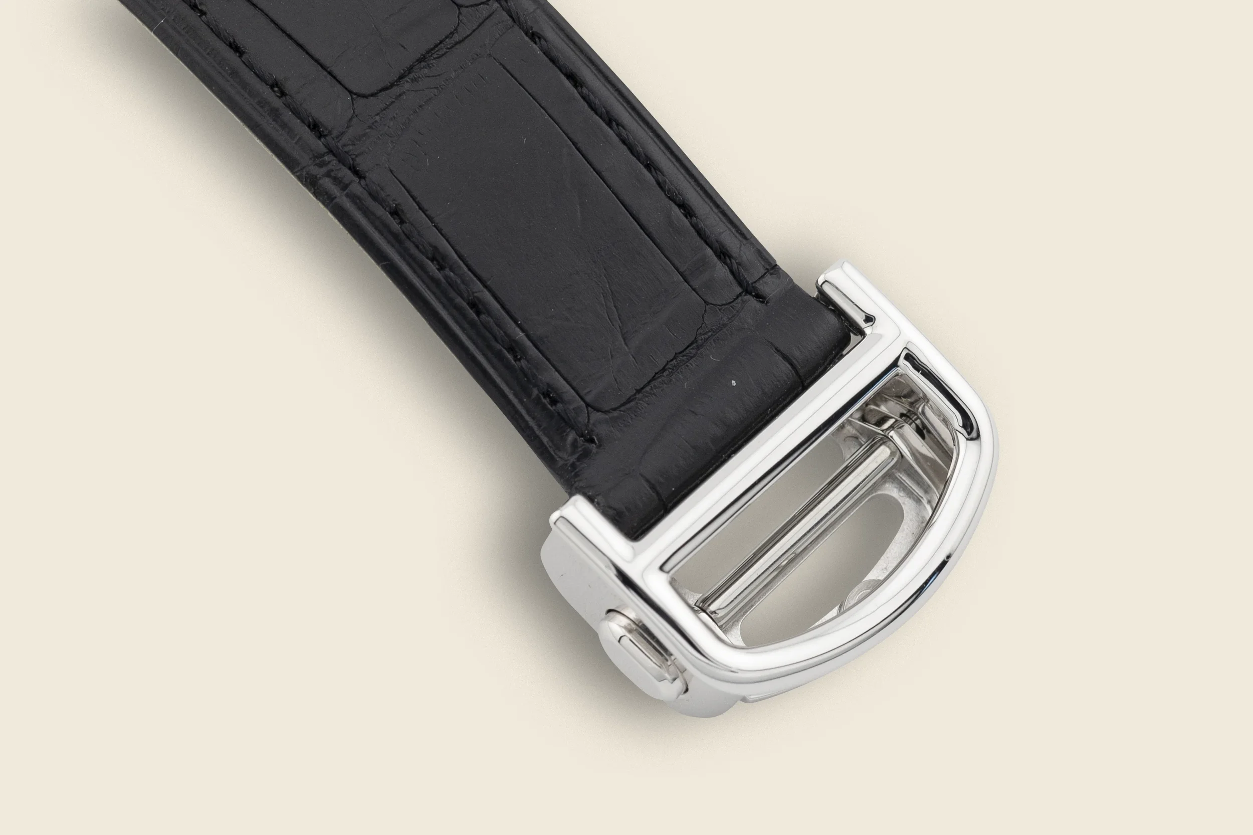 Close-up of a black leather belt and the silver buckle part of a skipped razor.