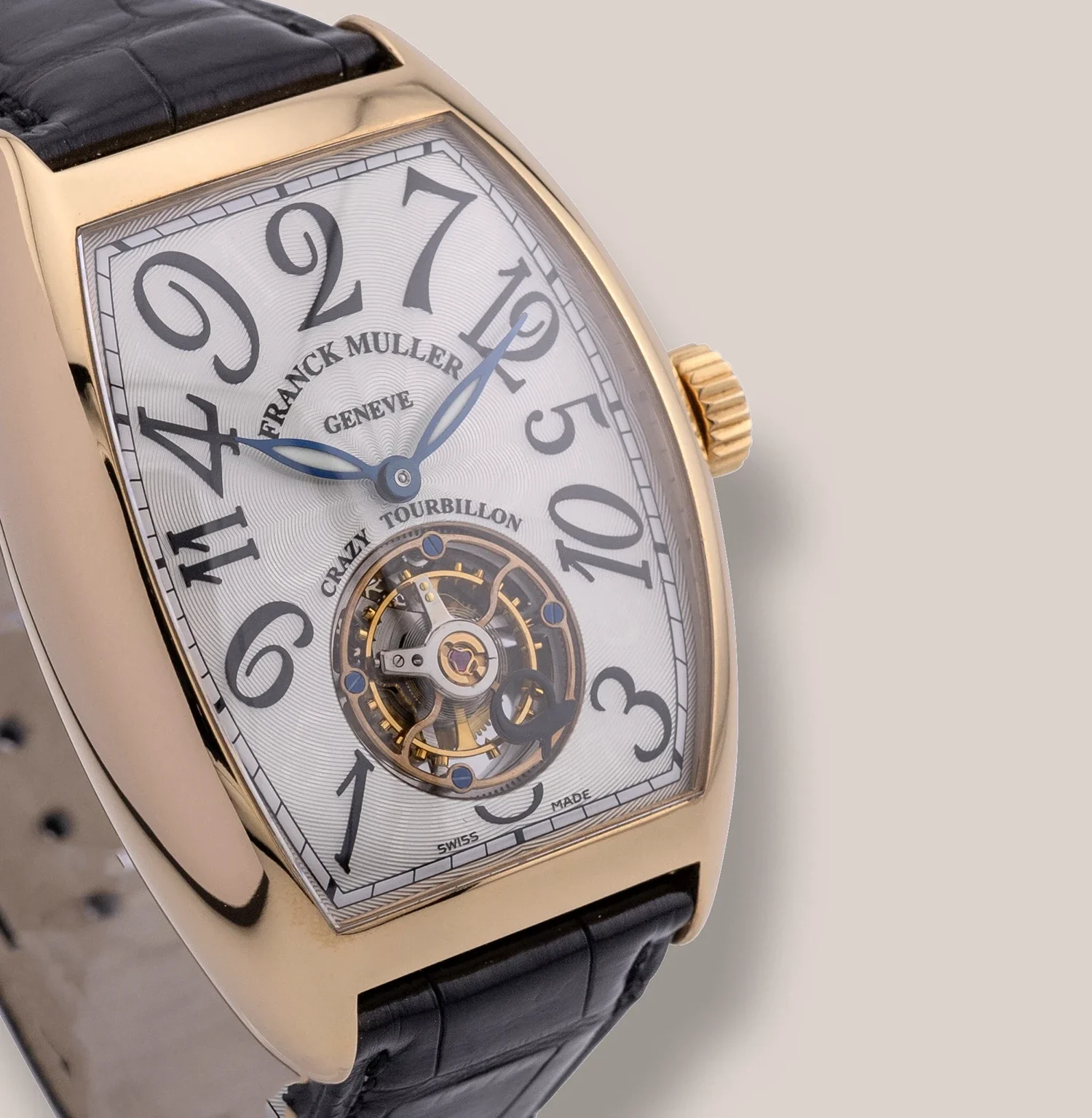Close-up of a Franck Muller Genève luxury watch with a gold case