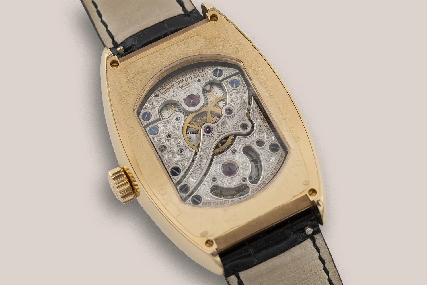 luxury wristwatch with a rose gold case and a black leather strap