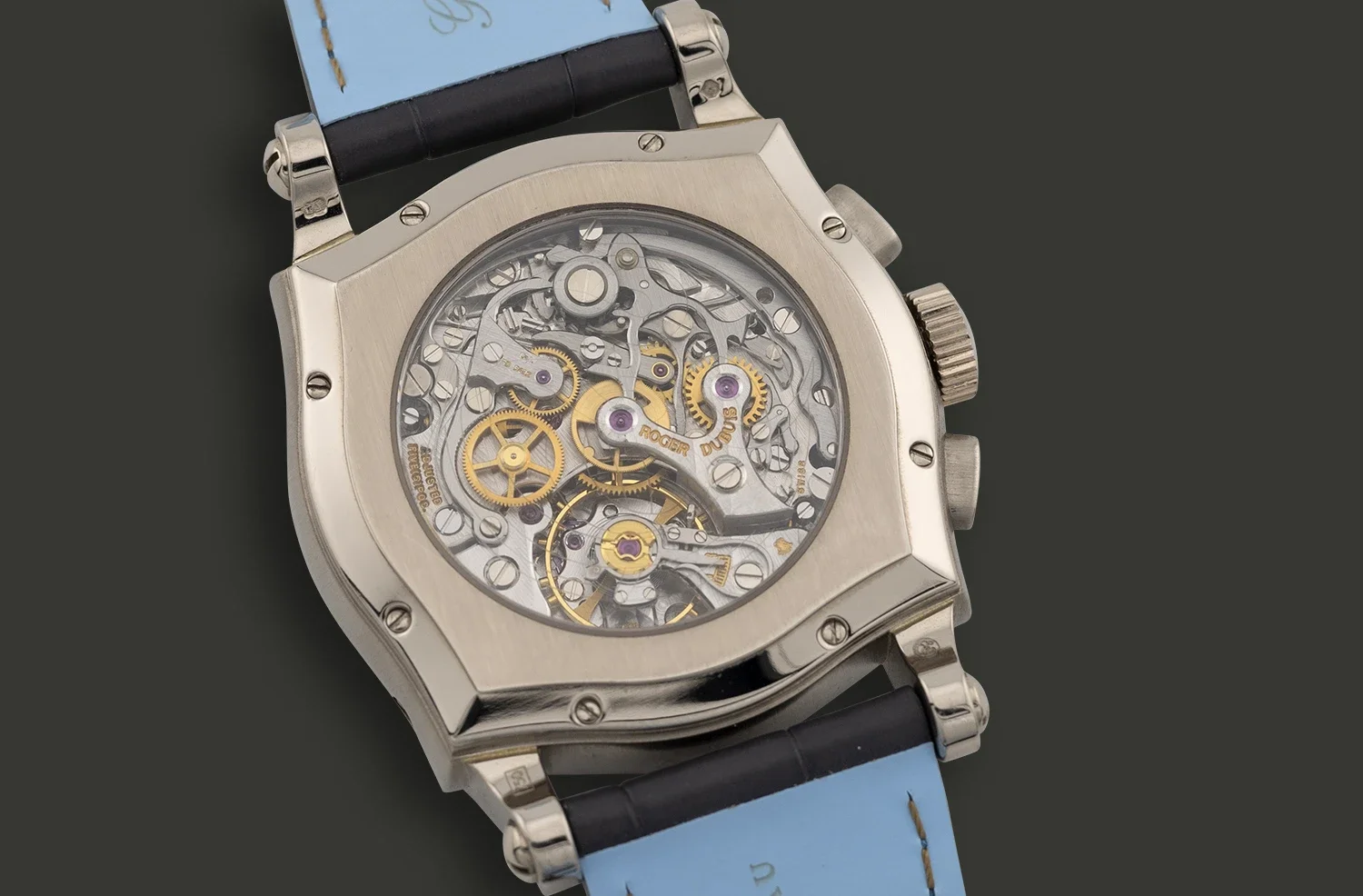 A luxury watch with a skeleton dial showing its intricate inner gears and mechanisms, with a light blue strap and a dark background.
