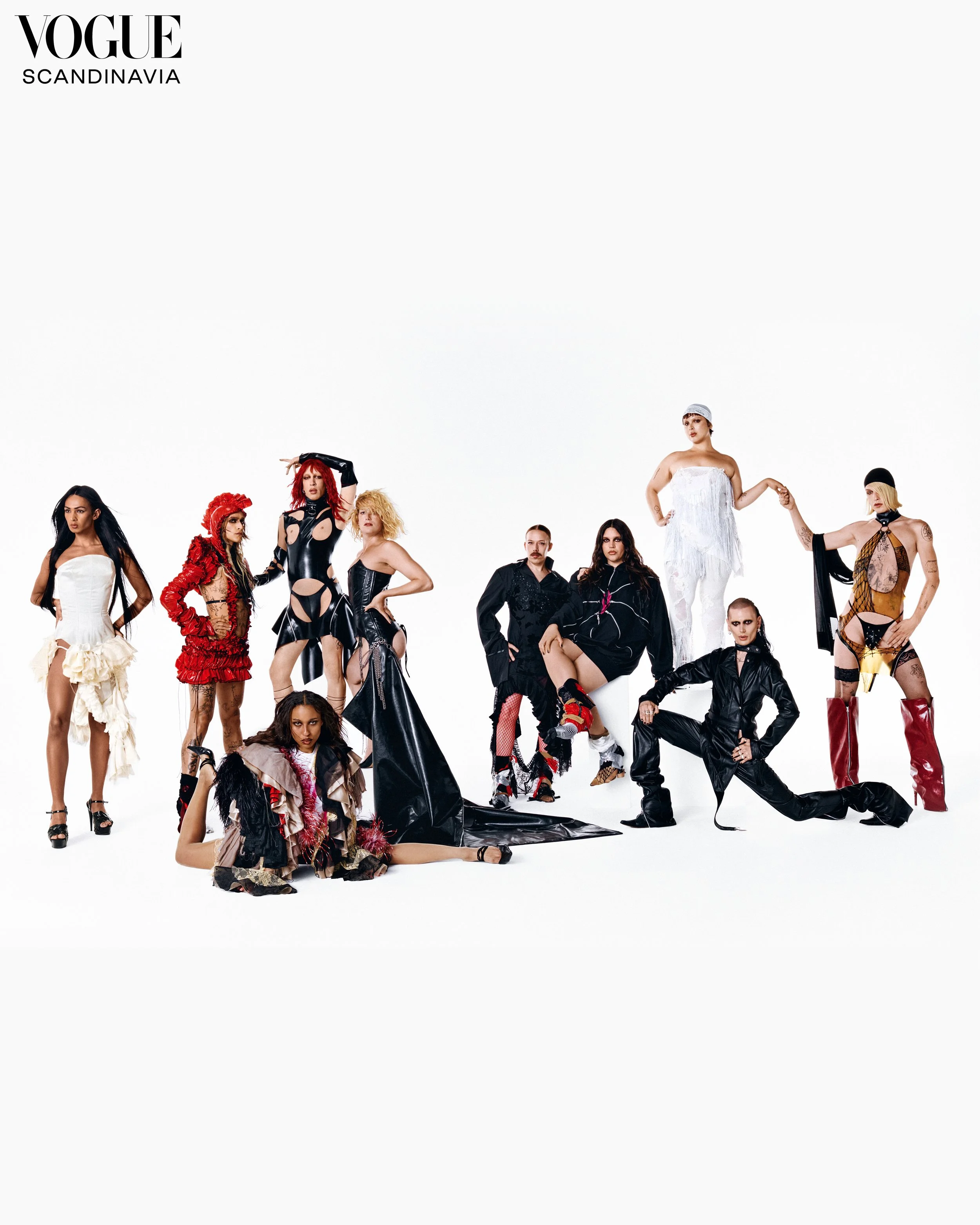 A group of diverse women posing together in designer outfits on a white background, with the Vogue Scandinavia logo in the top left corner.