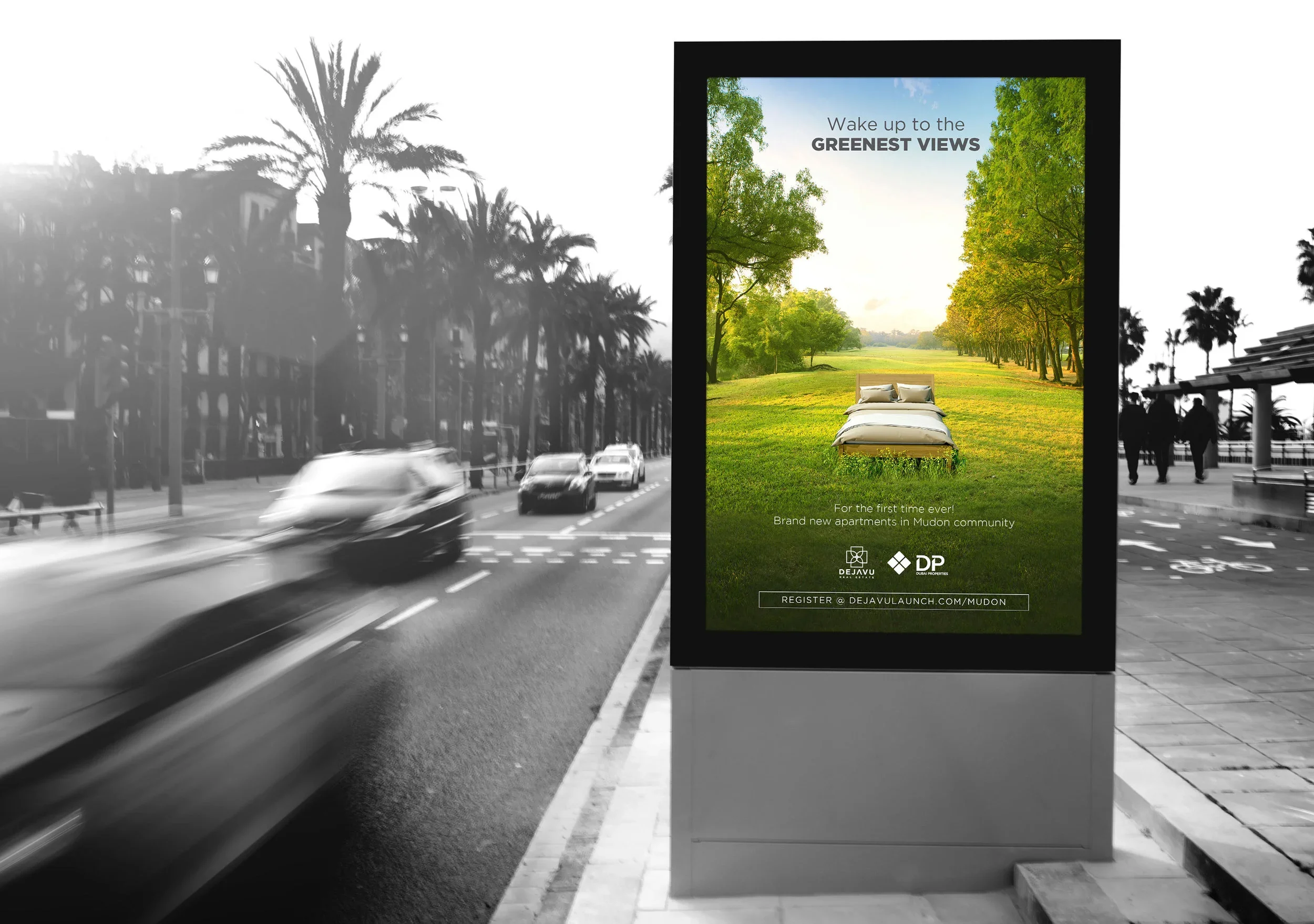 Digital billboard advertising new apartment complex in Mudon community with a photo of a park and text encouraging viewers to register.