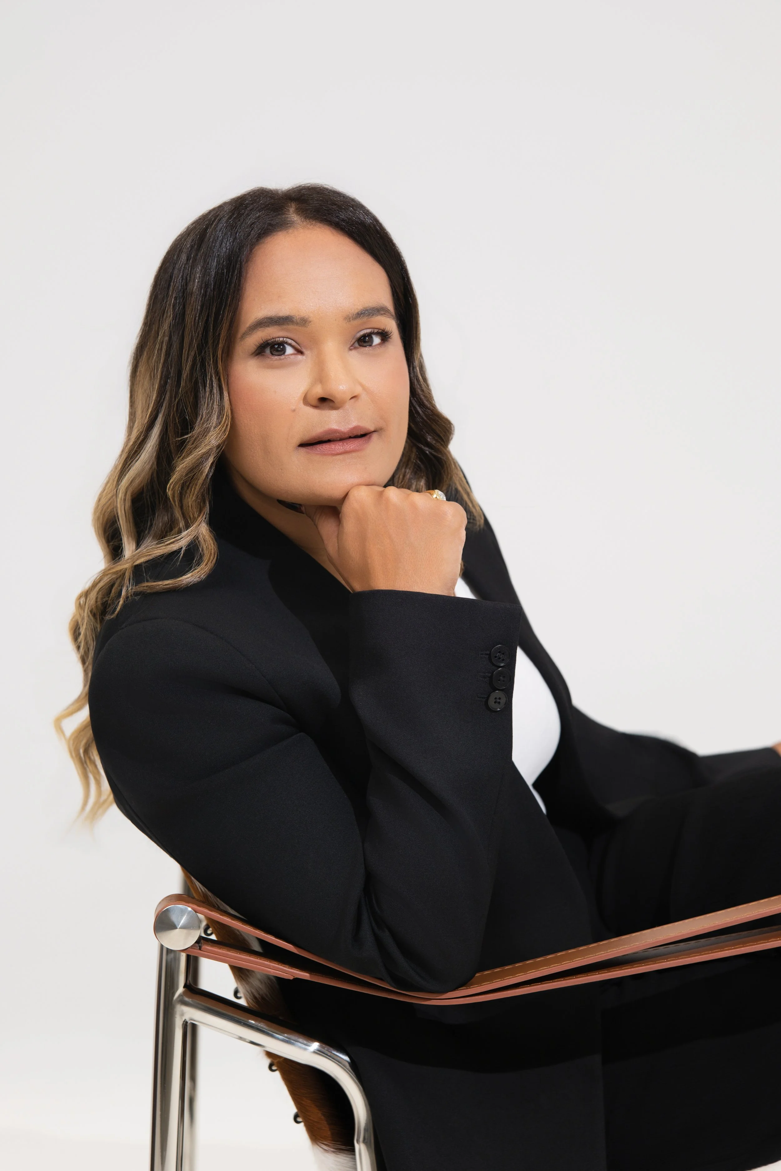 Dr. Karin Lorez, Founder of Lorez Advisory, seated in a black blazer with her chin resting on her hand.