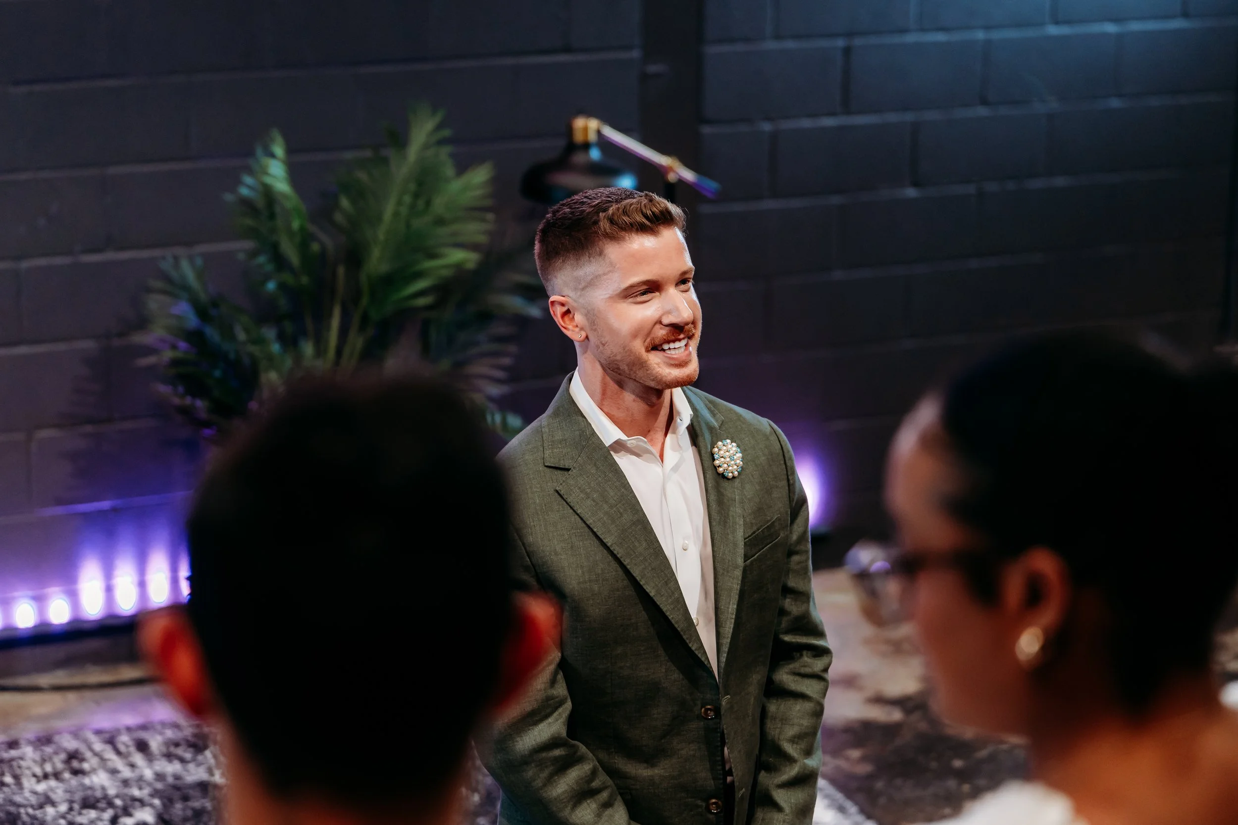 Blake Mitchell speaking to guests at an illuminated event
