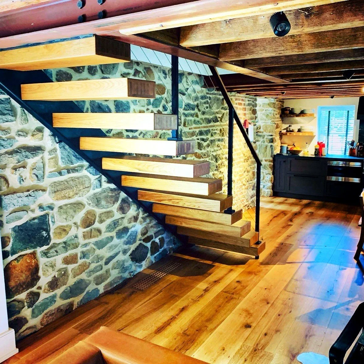 Floating stair against a stone wall