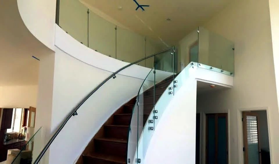 Curved floating stair with glass railing