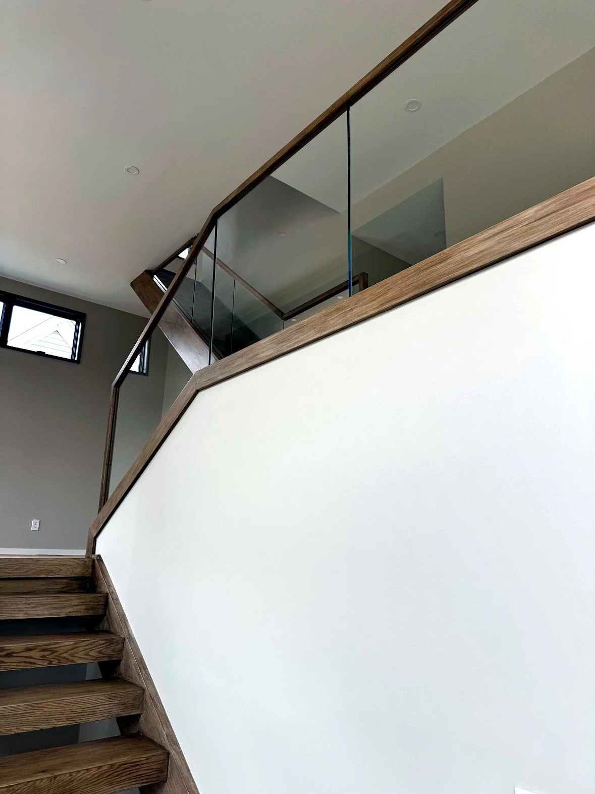 Glass railing in a wood channel