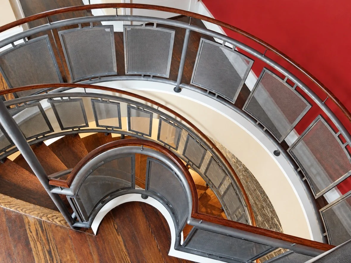 Curved mesh stair from above, showing the full curve