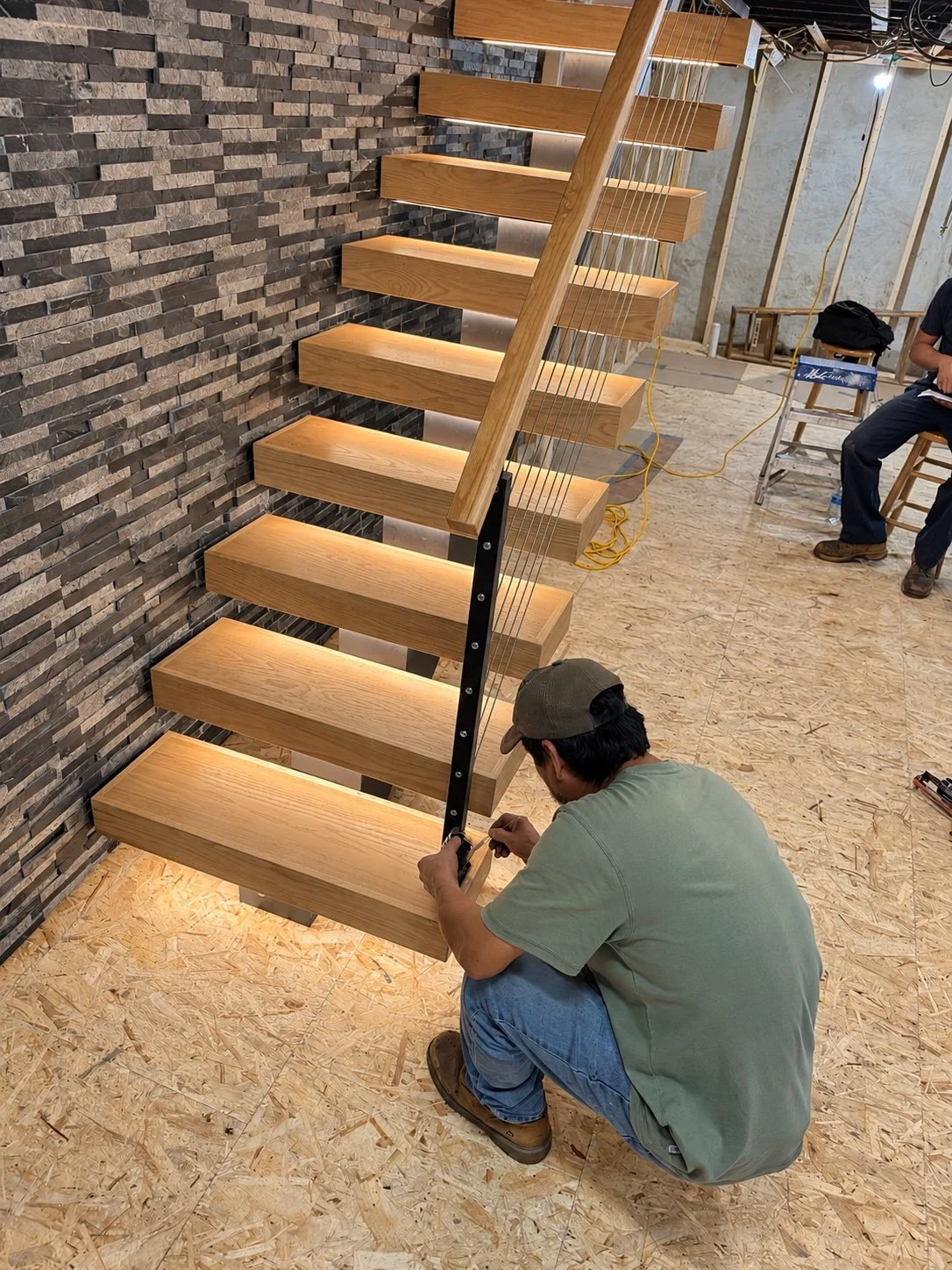 Pre-installed LED under-tread lighting, shown during installation
