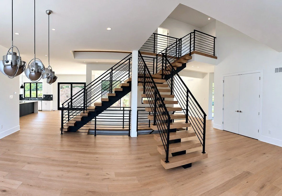 Floating switchback stair with black railings