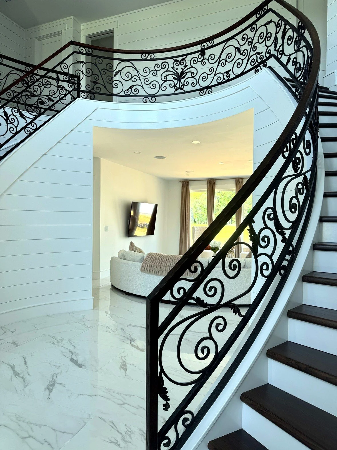 Curved stair with scroll railing