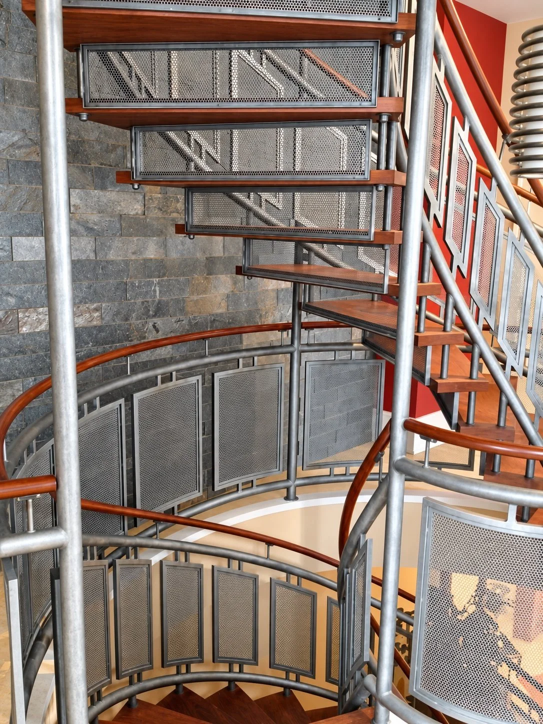 Underside of the curved mesh stair