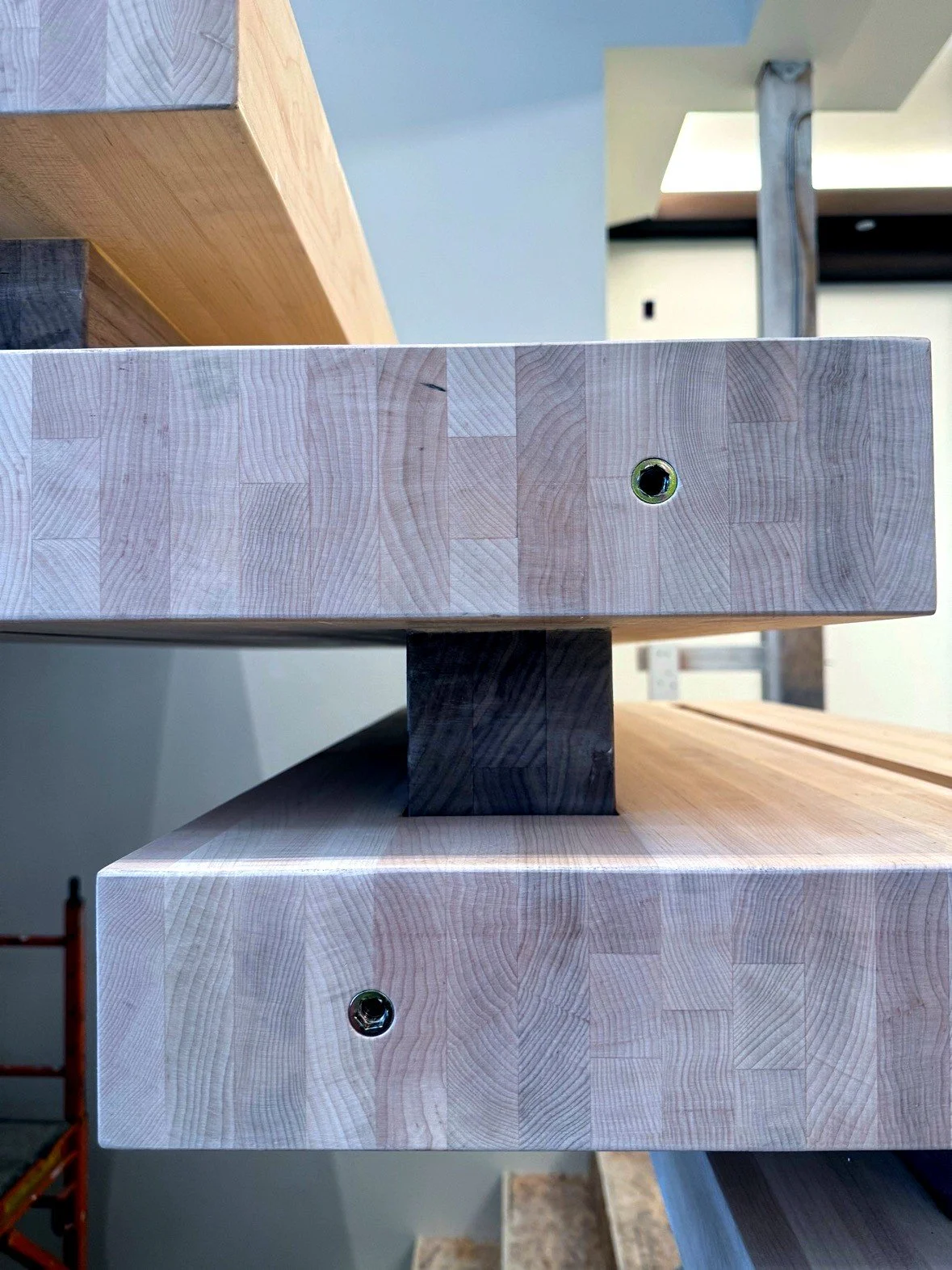 The Blockley stacked-block staircase, close-up of a spacer block at the end of a tread