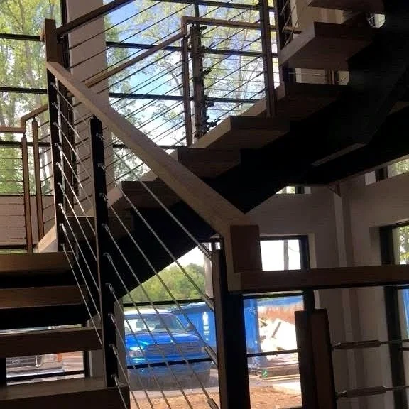 Cable railing with wood handrail, close-up
