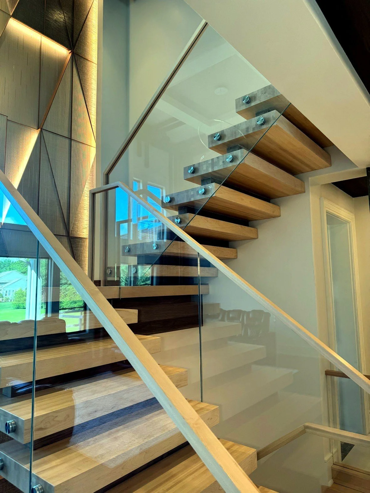 Floating stair with glass railing, seen from below