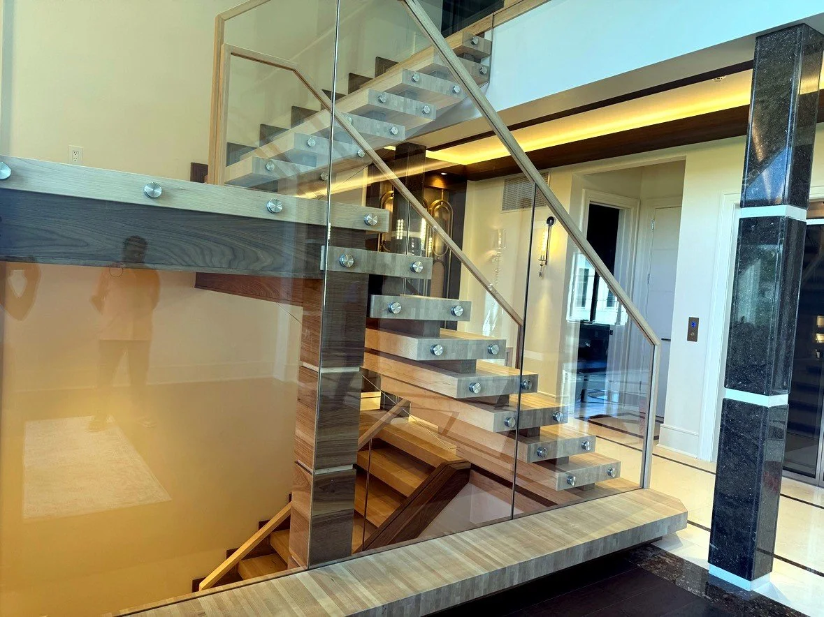 Floating stair with wood treads and glass railing