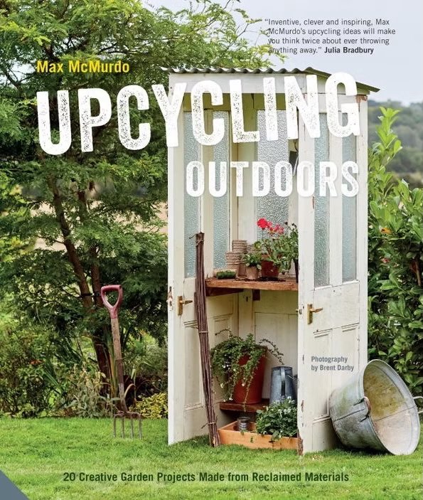 The cover of a book titled 'Upcycling Outdoors' by Max McMurdo, featuring a repurposed outdoor structure resembling a small shed or cabinet, filled with gardening tools, plants, and recycled materials, set in a garden.