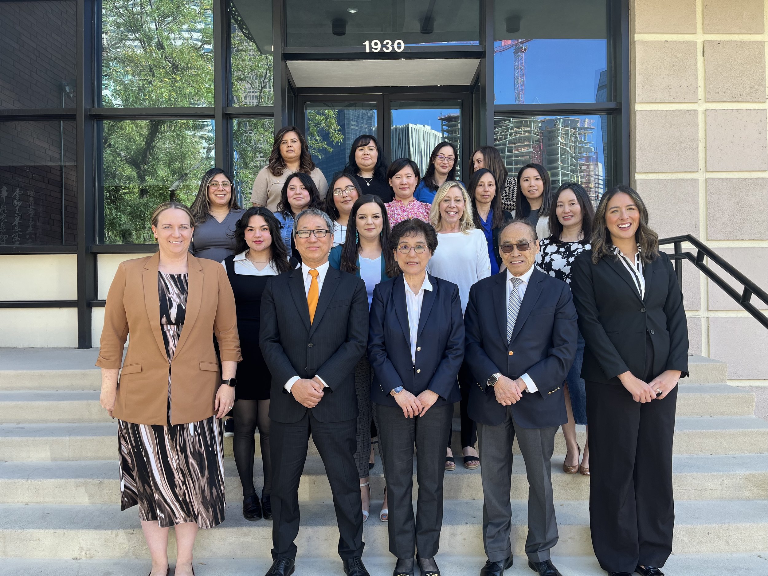 Lau & Choi, P.C. immigration attorneys and staff standing outside their Denver, Colorado office.