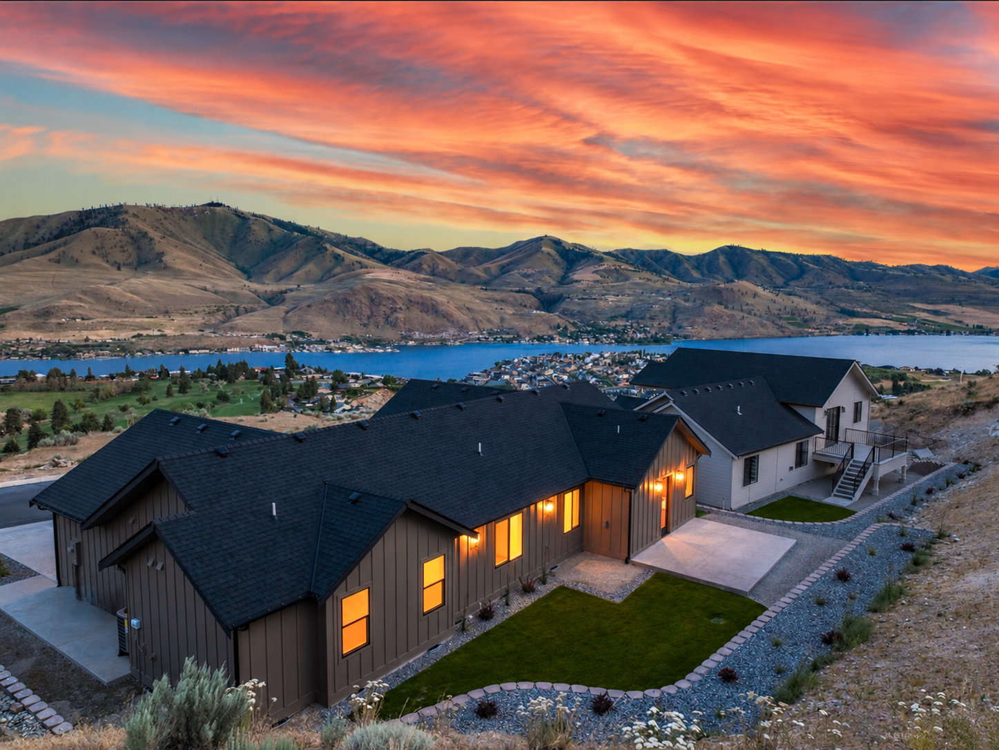 Sunset hillside above lake and mountains.png
