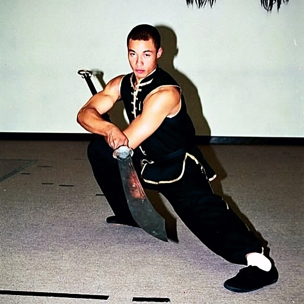 James Whitley III in a low stance holding a Chinese broadsword