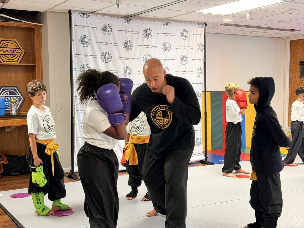 James Whitley III coaching a young student in sparring at his kung fu school
