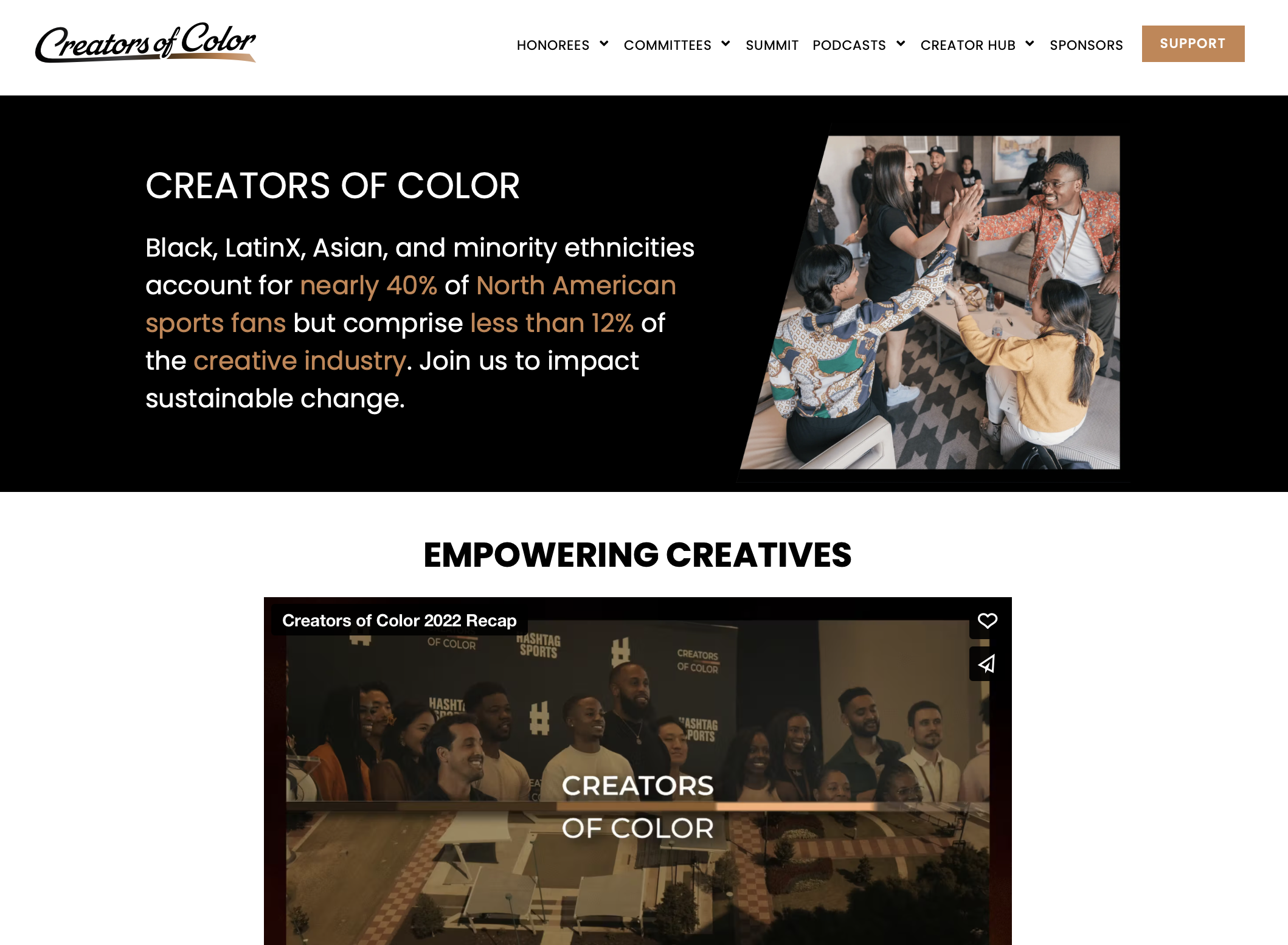 Website page for Creators of Color with a header, navigation menu, and a main section featuring a group of diverse people at an event, some high-fiving, around a table.