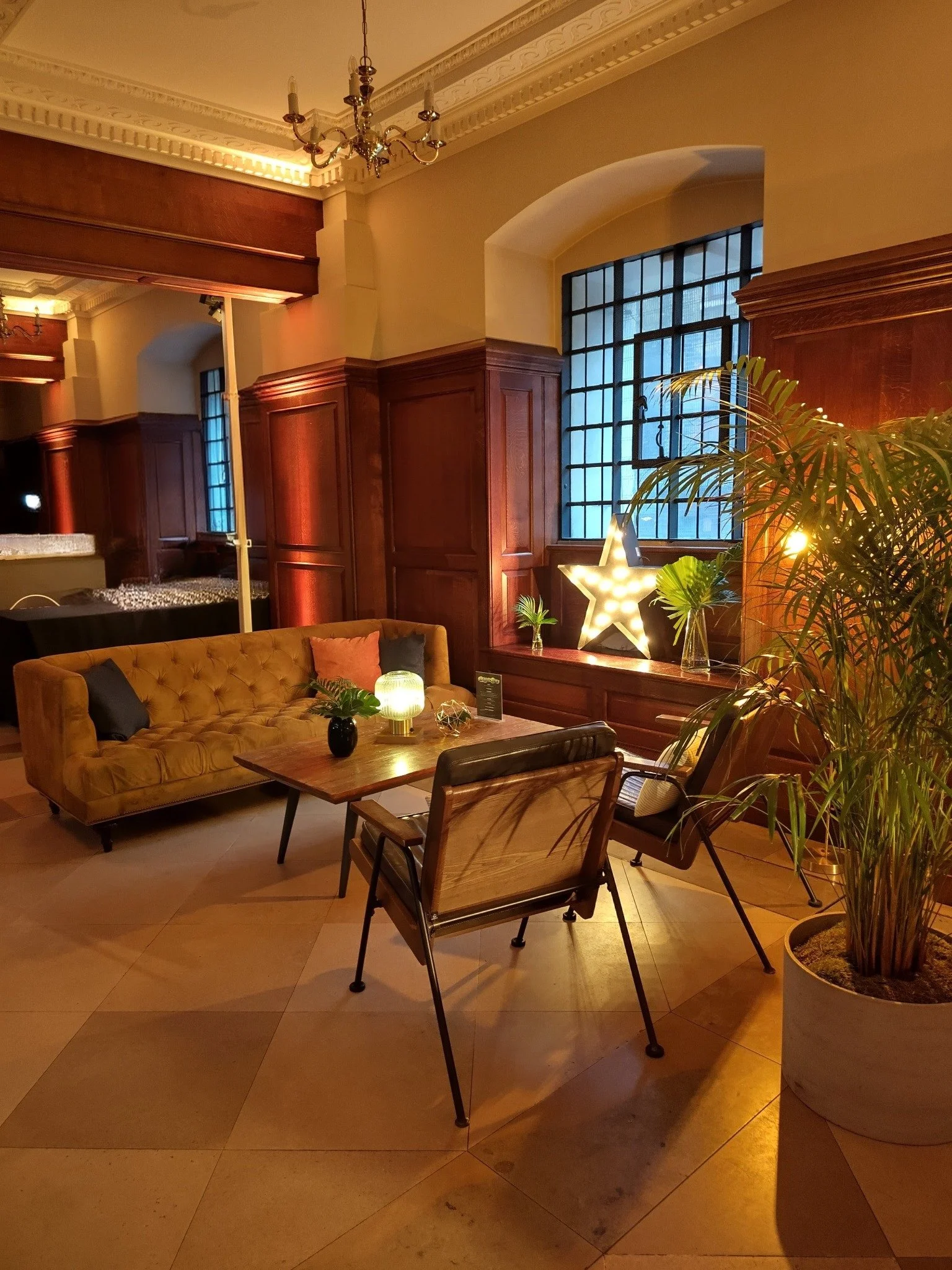 Sofas and armchairs arranged as a warmly lit lounge in the Nave at Christ Church Spitalfields