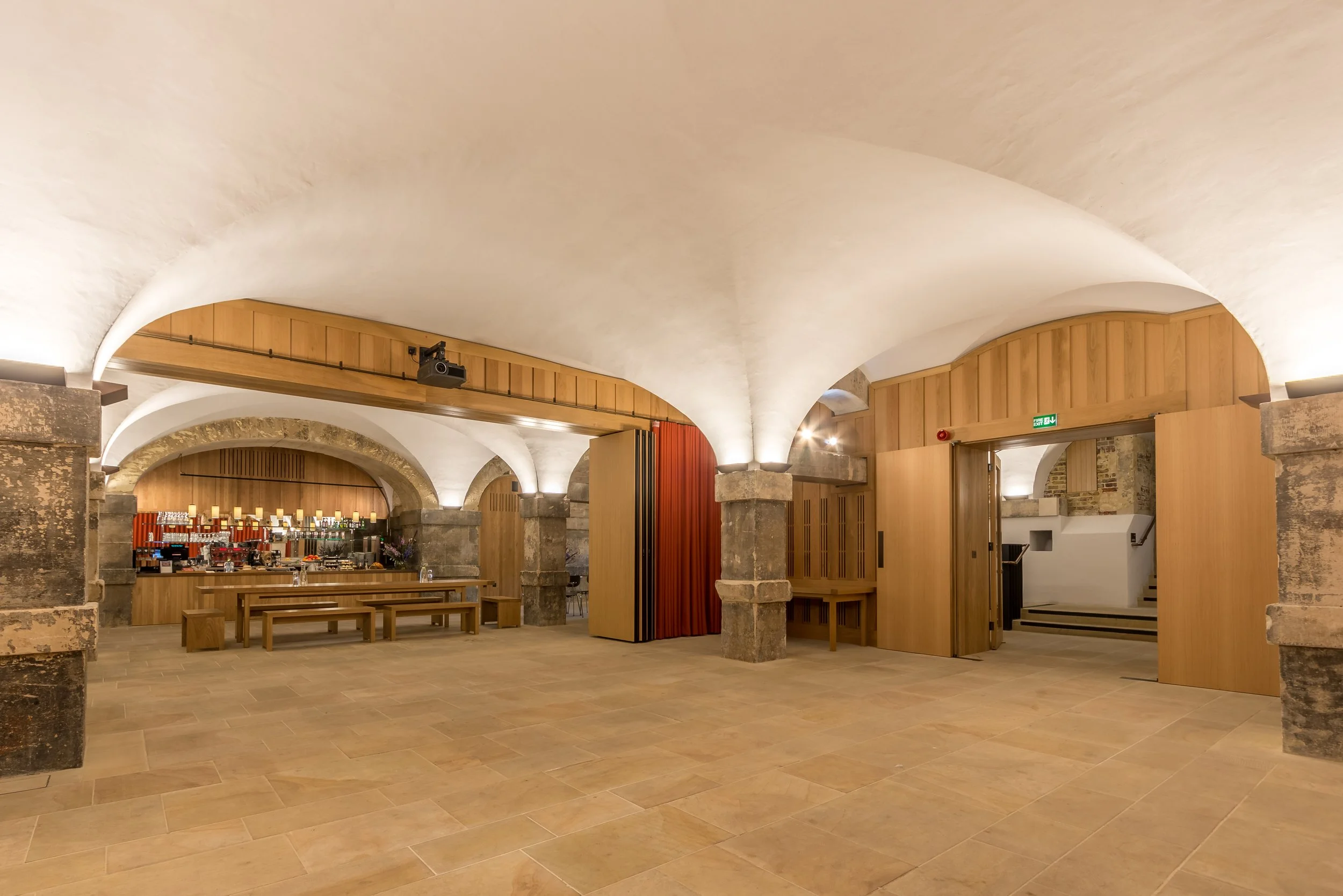 Crypt interior at Christ Church Spitalfields, with light oak finishes and historic architectural details.