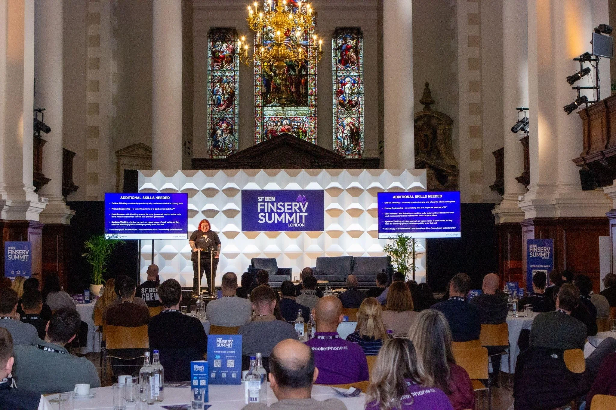 Speaker presenting at the Finserv Summit in the Nave at Christ Church Spitalfields.