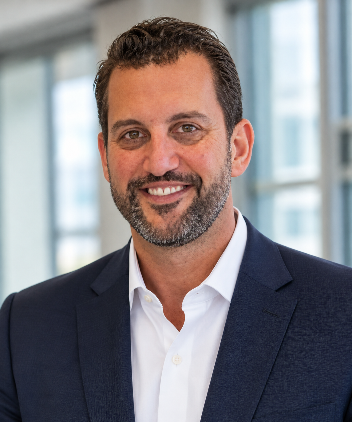 A professional headshot of Eitan Sasson