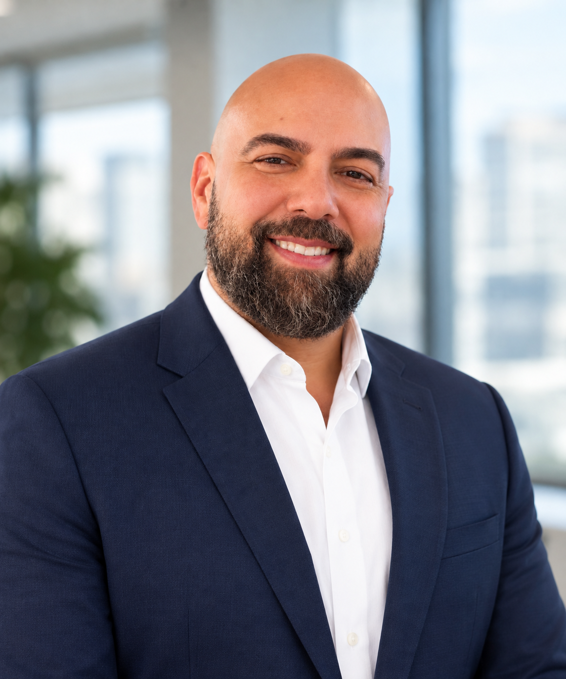 A professional headshot of Kenny Tencer