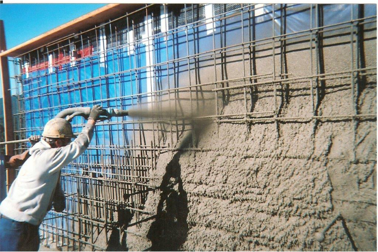 Deluxe Shotcrete owner Jesse Humphreys applying structural shotcrete to a reinforced concrete wall.