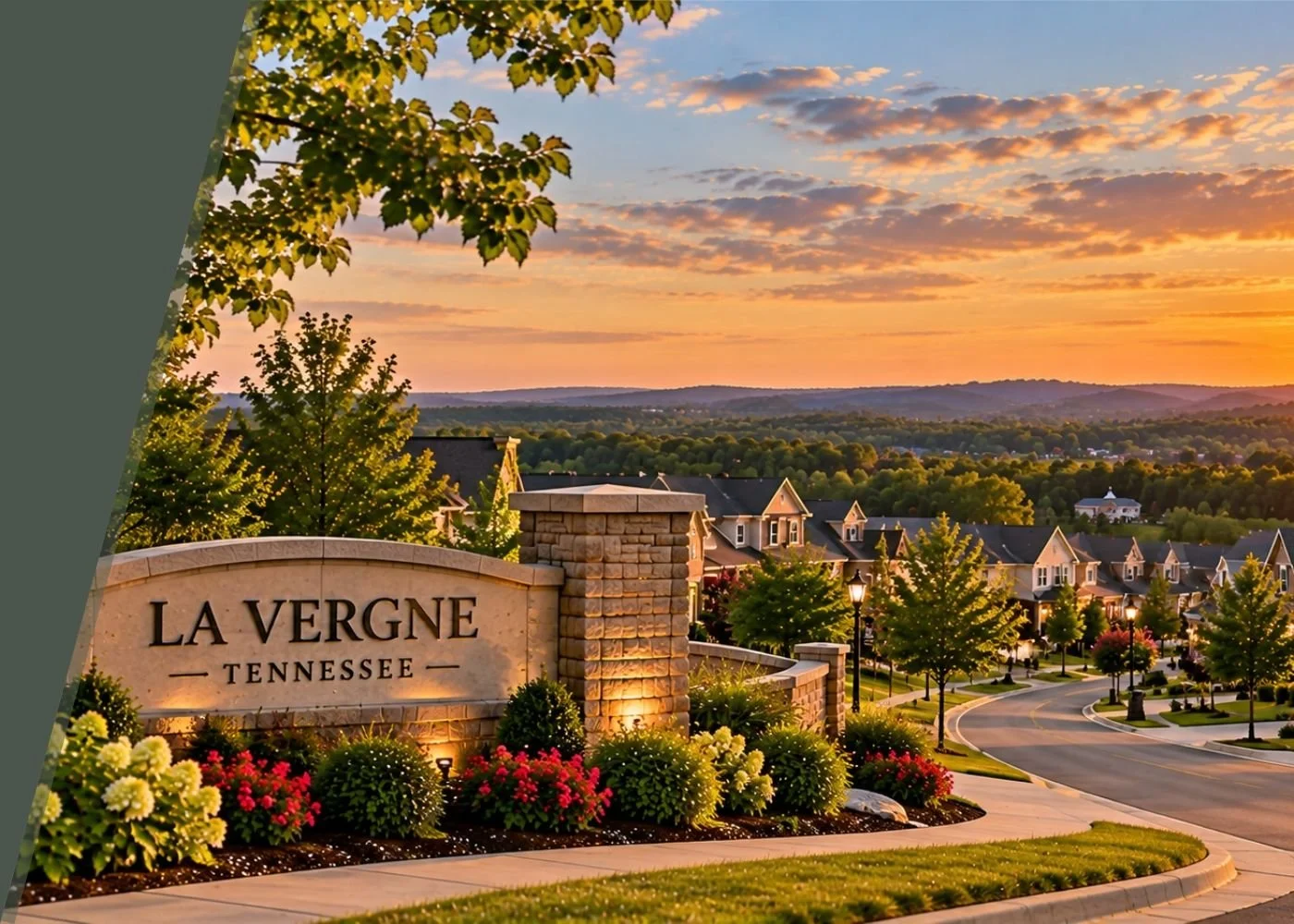 Welcoming entrance sign reading 'La Vergne Tennessee' surrounded by flowers, trees, and residential houses at sunset