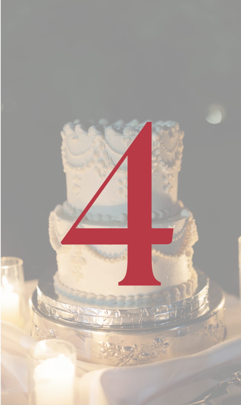 Elegant white tiered wedding cake on a silver pedestal with candles and a large red number four overlay